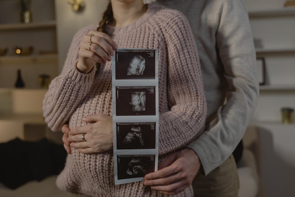 Expectant couple indoors holding ultrasound, symbolizing new life and family bonds.