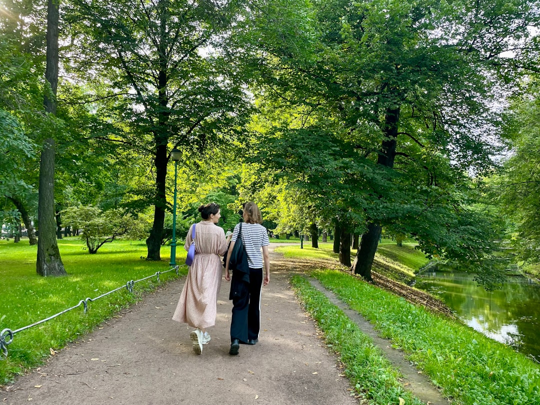 A man and woman walking down a path in a park