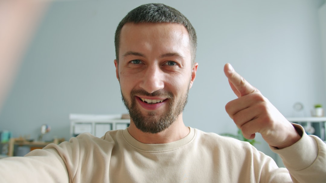 Man smiling and giving a thumbs up gesture.