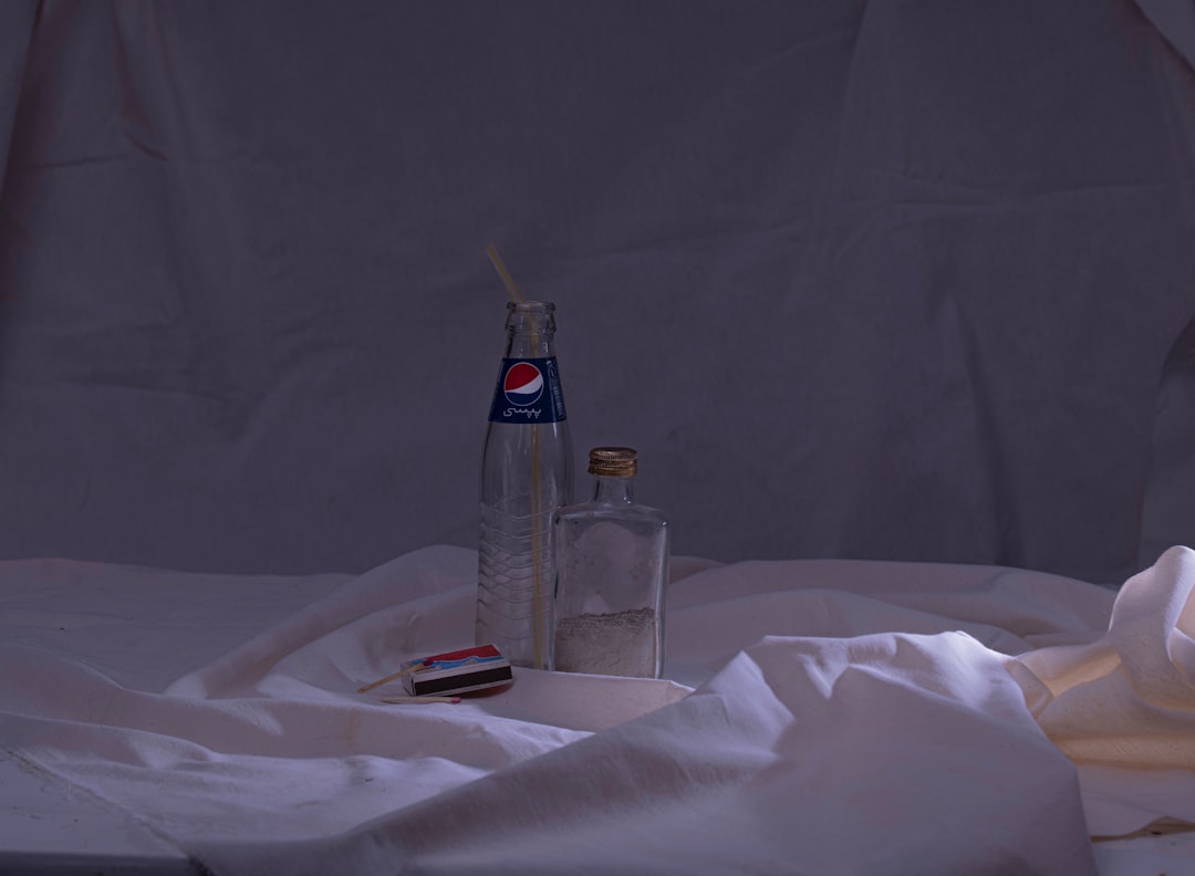 a bottle of toothpaste and a tube of toothpaste sit on a