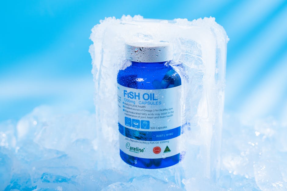 Close-up of frozen fish oil capsules in a blue bottle, highlighting purity and health benefits.