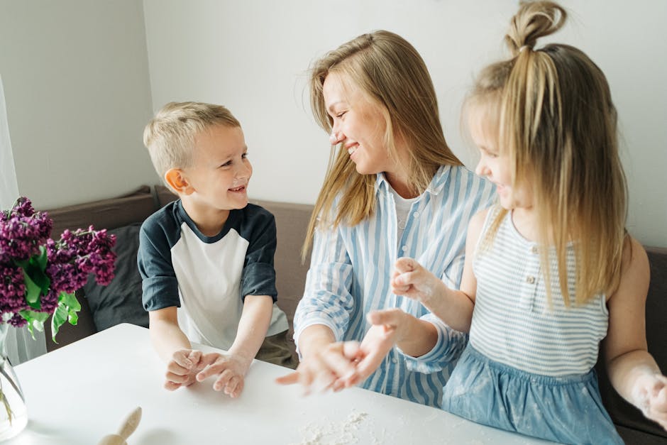 A mother and her two children enjoy a fun baking session inside their home.
