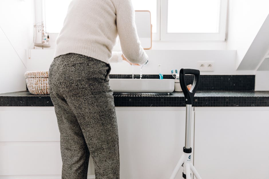 A senior adult using a rollator in a modern bathroom with sleek design elements.